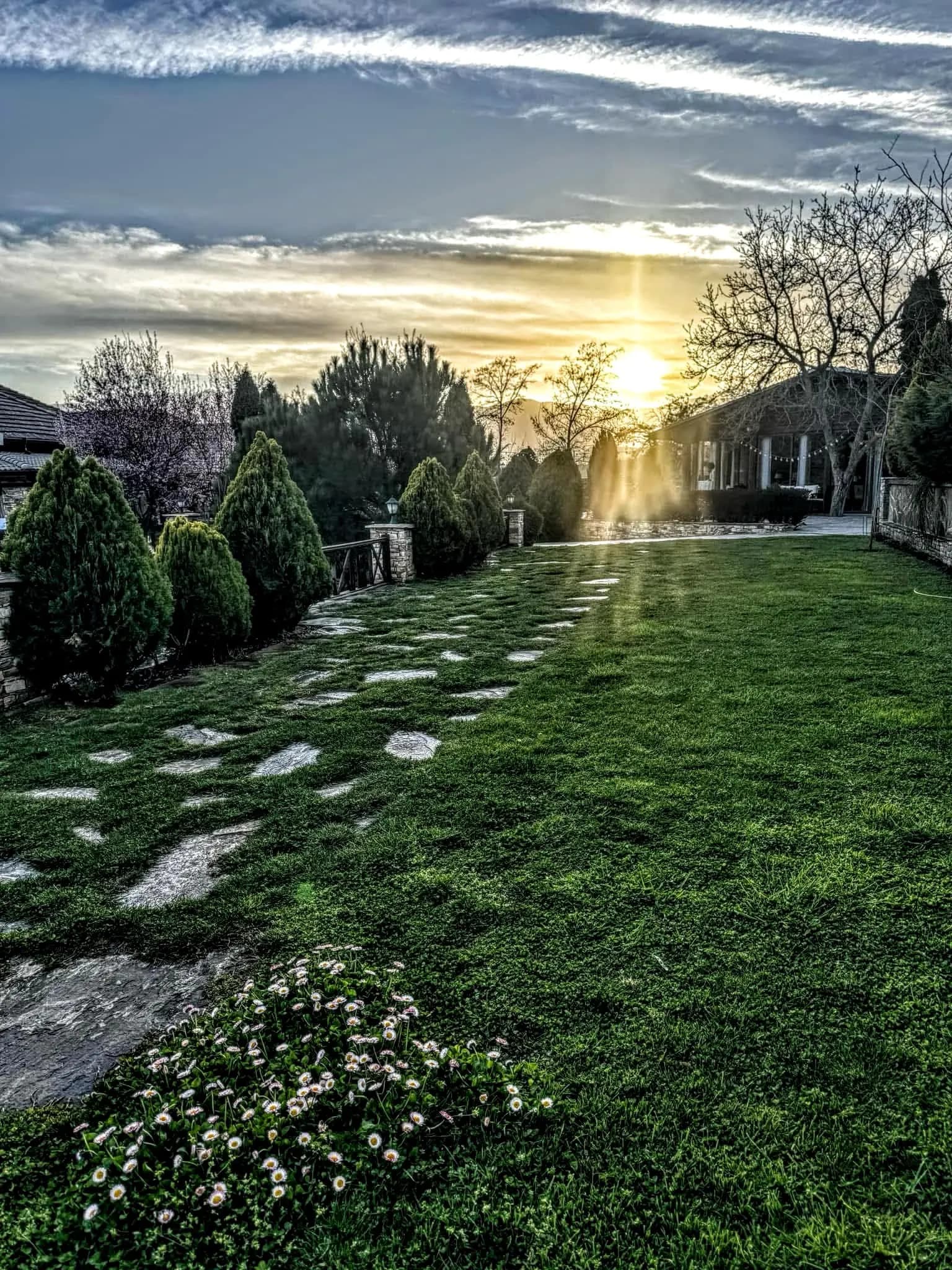 Golden light over the lawn in the gardens of Bozhe Ime