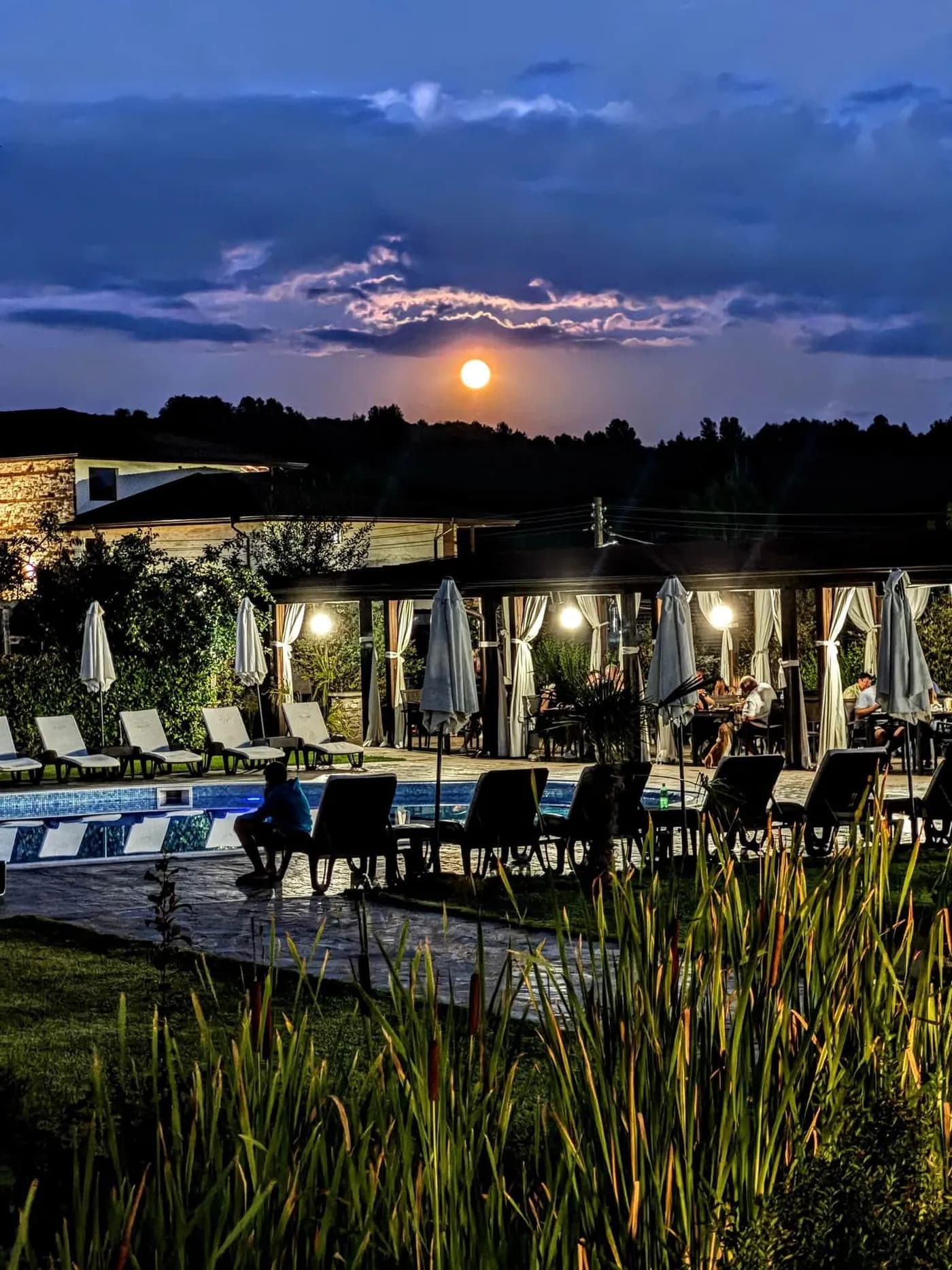 Градинската тераса на ресторанта в Боже Име Spa & Park, с перголата и дървения мост
