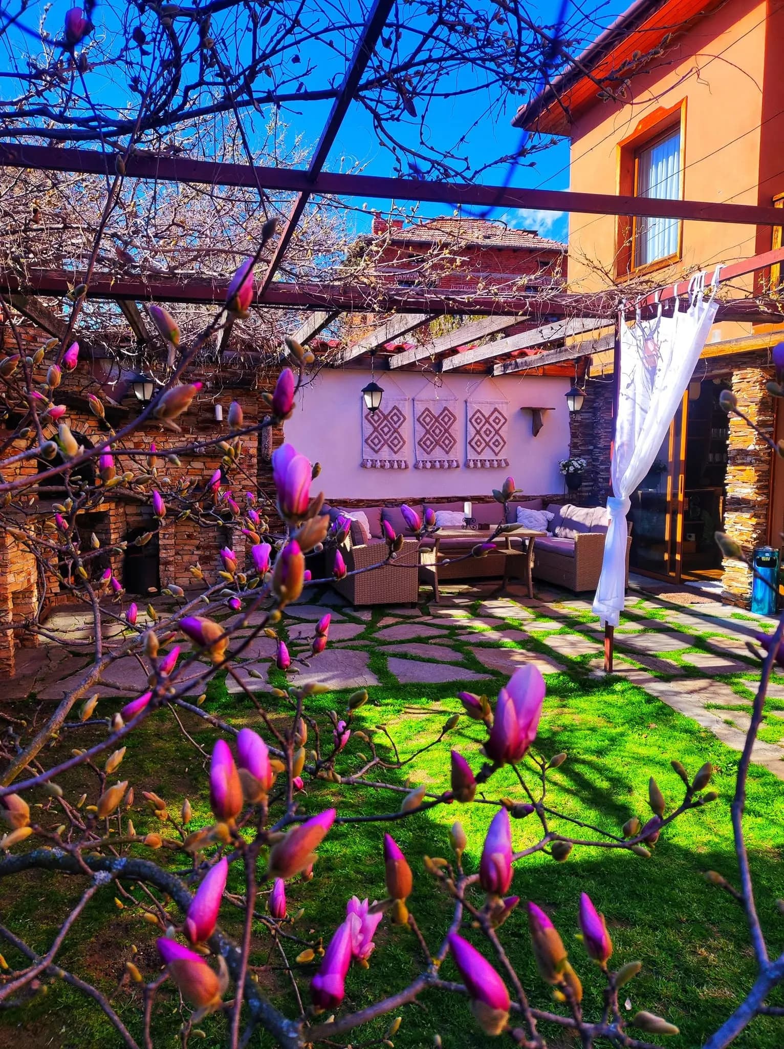 The courtyard of Bozhe Ime Villa in Baldevo, the wisteria in bloom